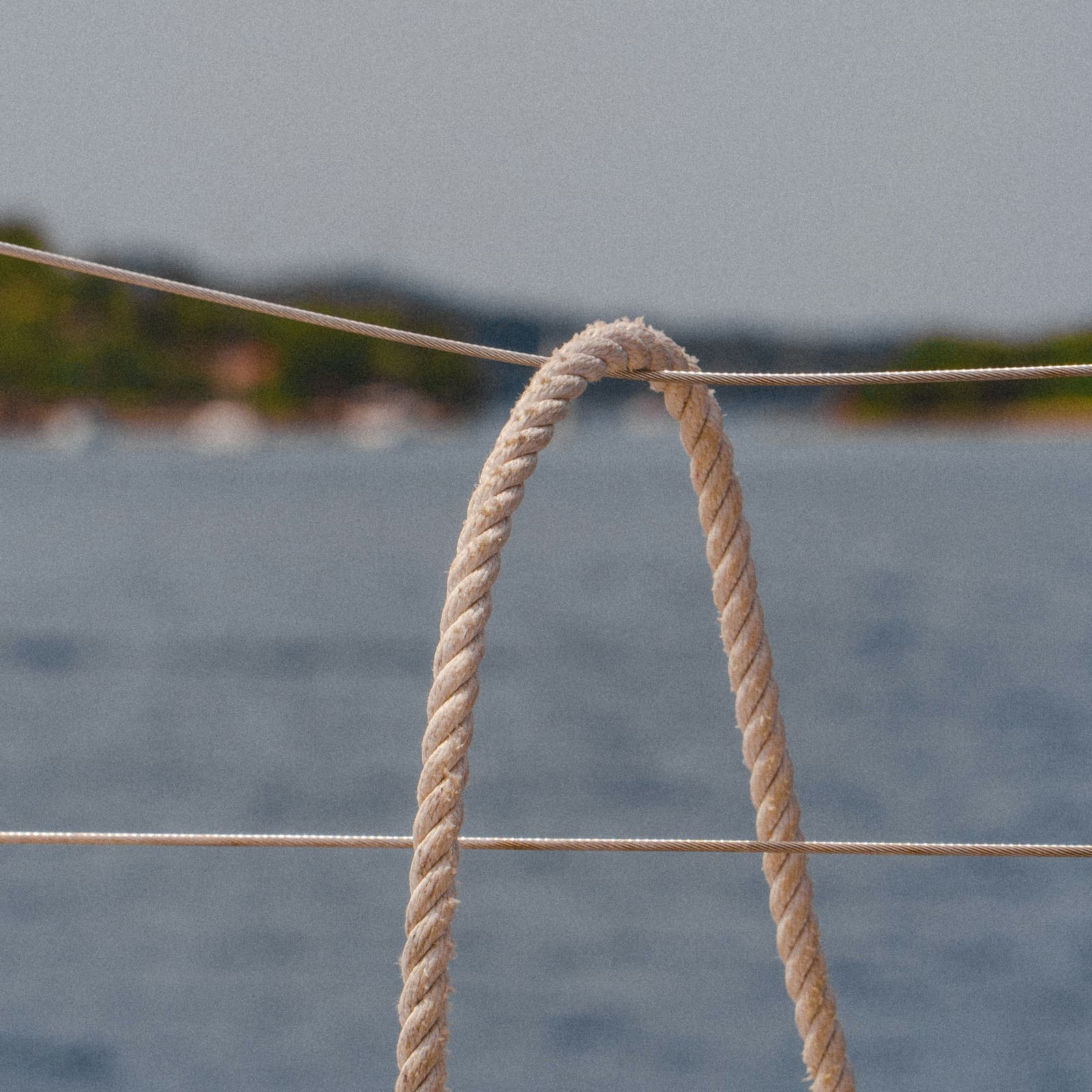 Coiled deck rope aboard a yacht, with the water behind