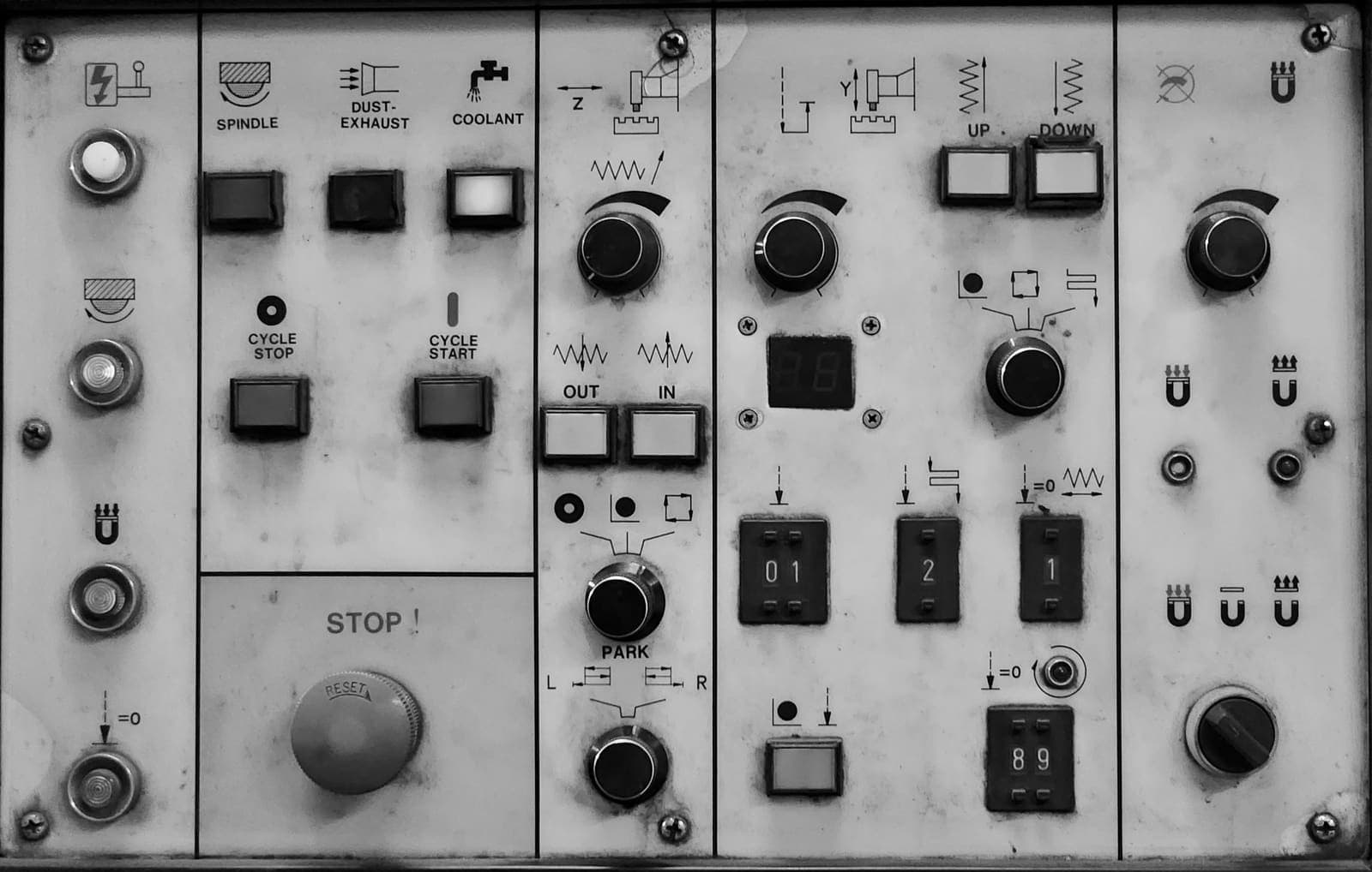 A close-up of an electronic control panel with switches and dials