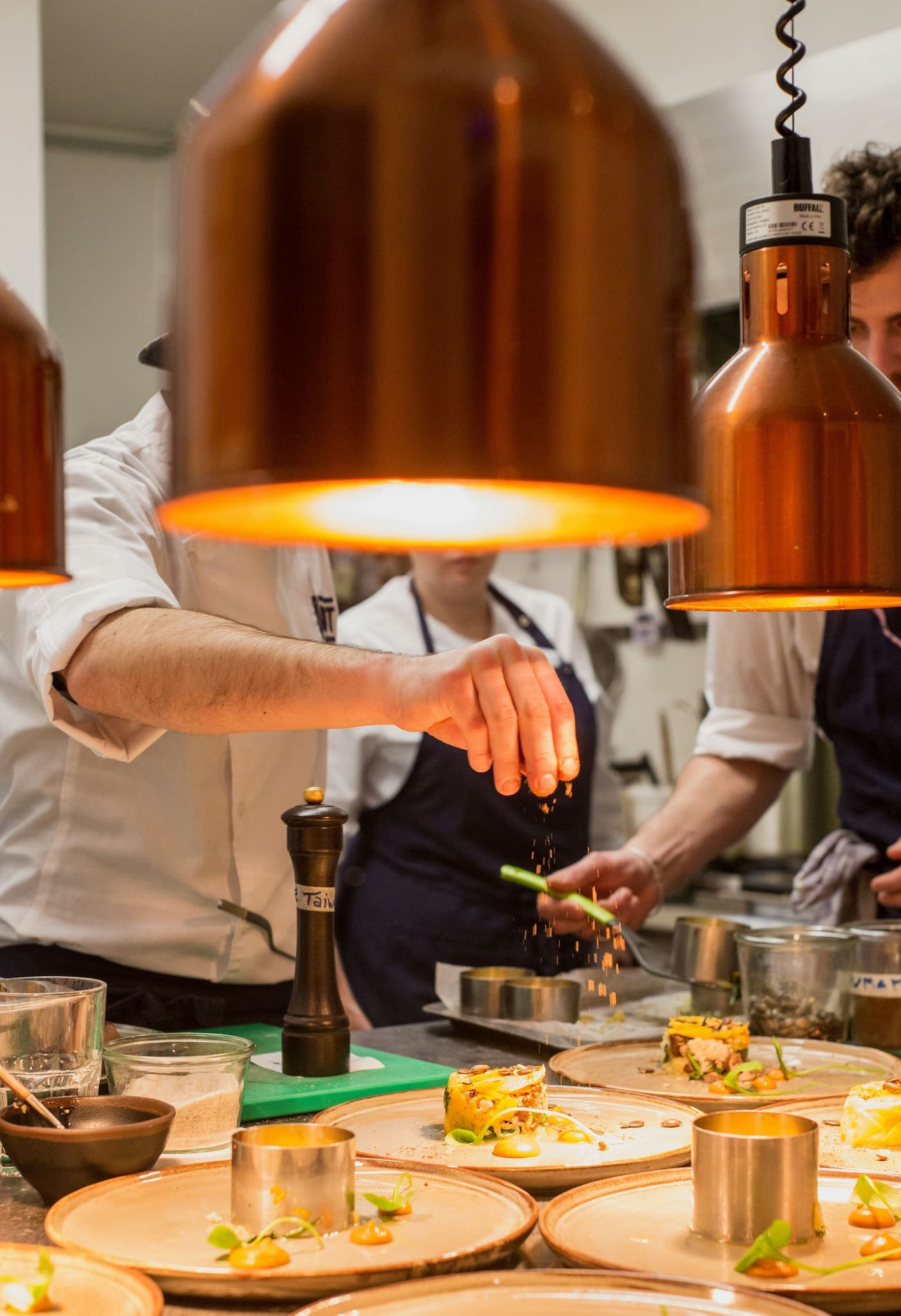 A chef plating food in a professional kitchen