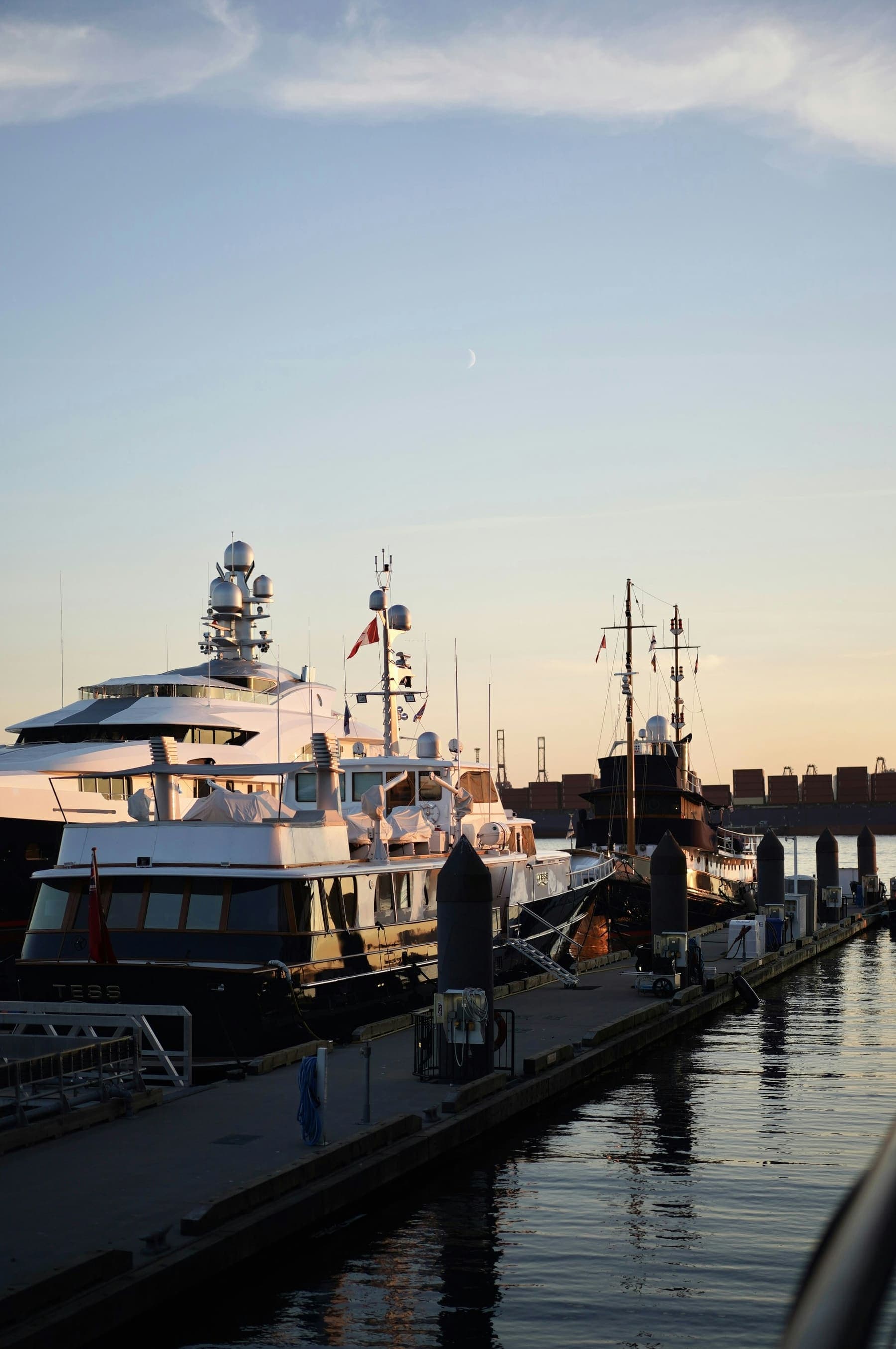 Superyachts moored at a dock at dusk