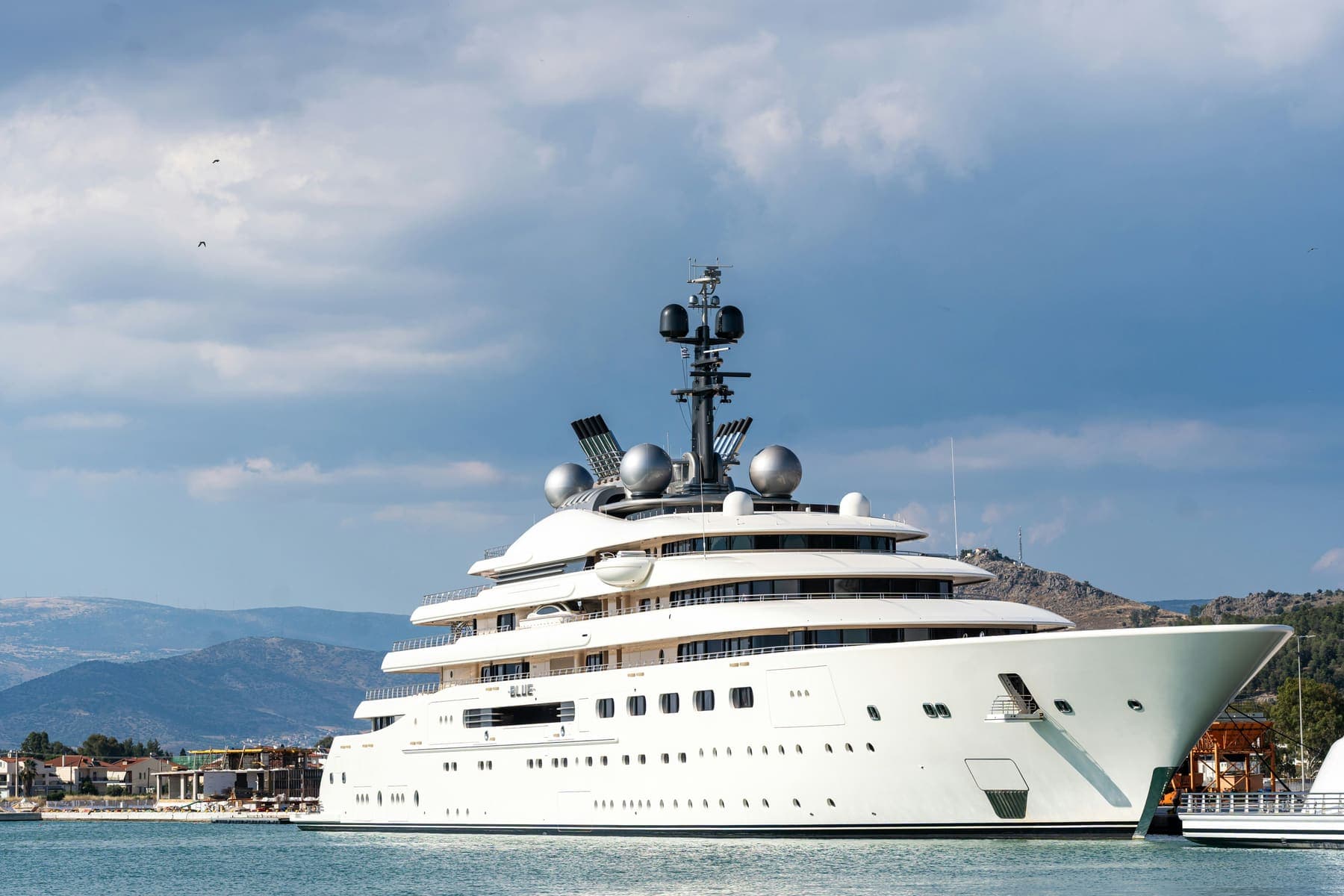 A large superyacht moored in a bay